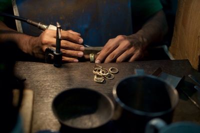 Midsection of man working at table in workshop