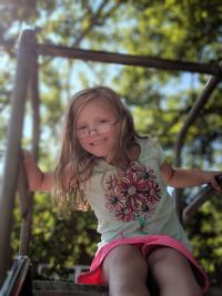 Portrait of smiling girl sitting outdoors