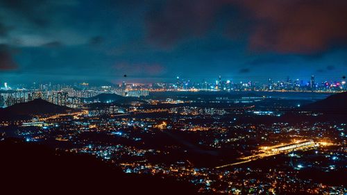 High angle view of illuminated city buildings at night