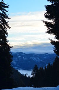 Scenic view of silhouette mountains against sky during winter