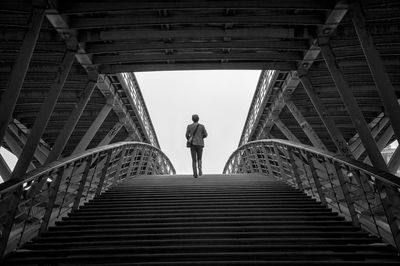 Low angle view of man climbing stairs