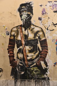 Digital composite image of man with graffiti on wall