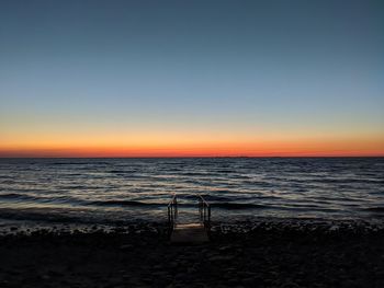 Scenic view of sea against clear sky during sunset