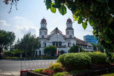 View of trees and buildings against sky