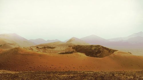 Scenic view of desert against clear sky