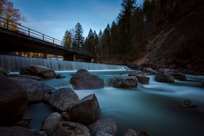 Scenic view of waterfall against sky