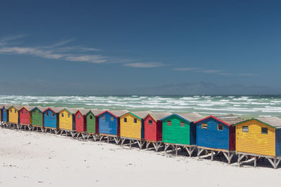 Famous colorful beach houses in muizenberg near cape town, south africa against blue sky