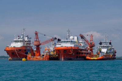 Commercial dock by sea against sky