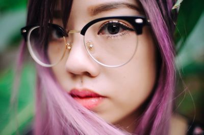 Close-up portrait of young woman with dyed hair