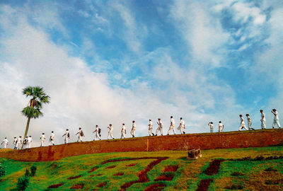 Navy people walking on retaining wall