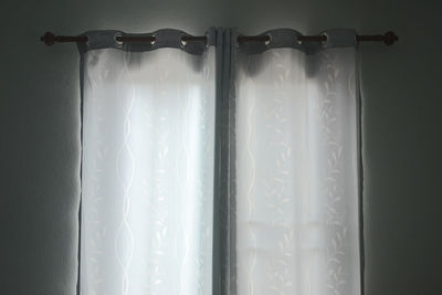 Close-up of curtain against window at home