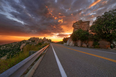 Road against cloudy sky during sunset