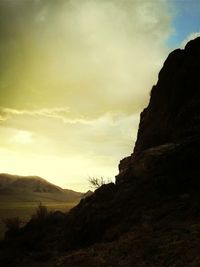 Scenic view of mountains against cloudy sky