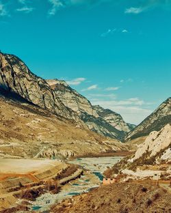 Scenic view of mountains against blue sky