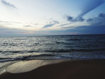 Scenic view of beach against sky during sunset