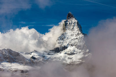 Panoramic view of snowcapped mountains against sky