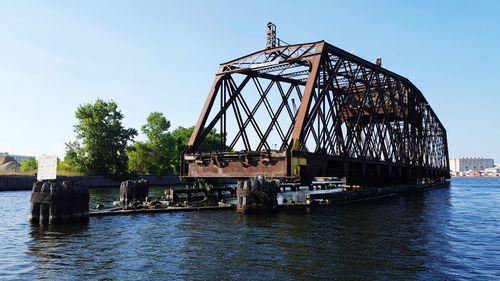 View of bridge over river against clear sky