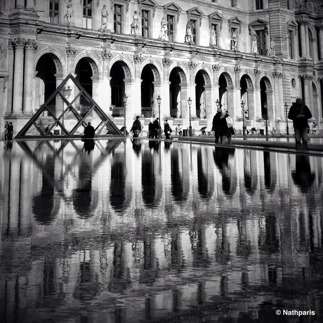 architecture, built structure, men, water, lifestyles, reflection, building exterior, arch, person, leisure activity, large group of people, walking, waterfront, tourist, history, travel destinations, city life, tourism, famous place