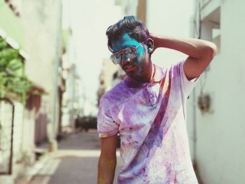 Portrait of young man wearing sunglasses standing outdoors