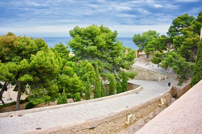 High angle view of footpath against cloudy sky