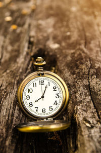 Close-up of a pocket watch on wooden table