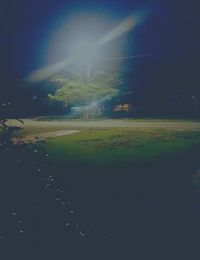 Scenic view of field against sky at night