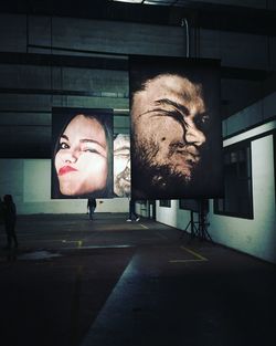 Portrait of man on road against wall in city