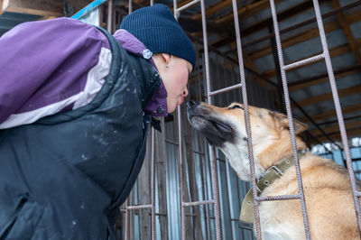 Girl volunteer in the nursery for dogs. shelter for stray dogs.