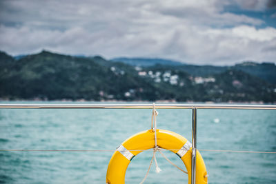 Life belt on boat railing at sea