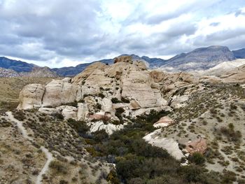 View of rocky mountains against cloudy sky