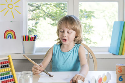 Cute girl holding ice cream at home