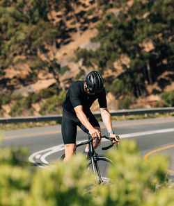 Man riding bicycle on road