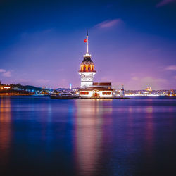 Illuminated buildings in city at waterfront