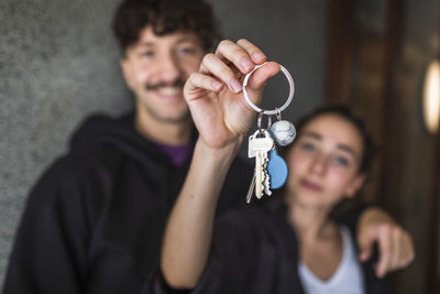 Couple showing keys to new apartment