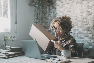 Young woman using laptop at office