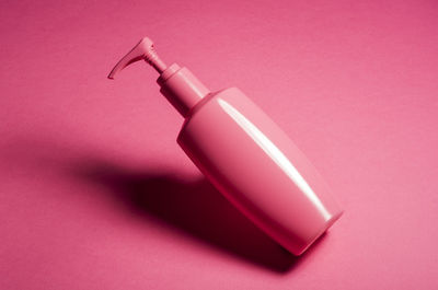 Close-up of bottle against pink background