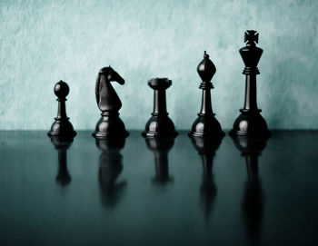 Close-up of chess pieces on glass