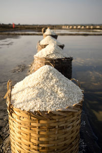 Close-up of stack in basket against sea