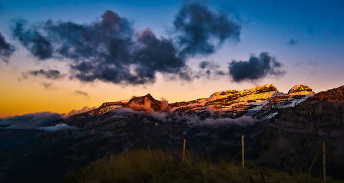 Scenic view of snowcapped mountains against sky during sunset