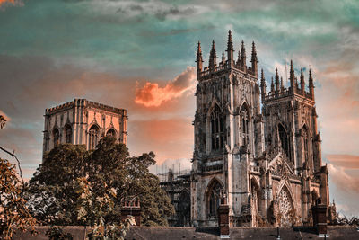 Traditional building against sky during sunset