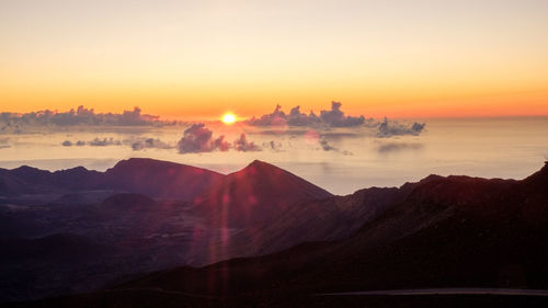 Scenic view of silhouette mountains against sky during sunset