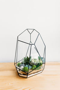 Close-up of glass on table against white background