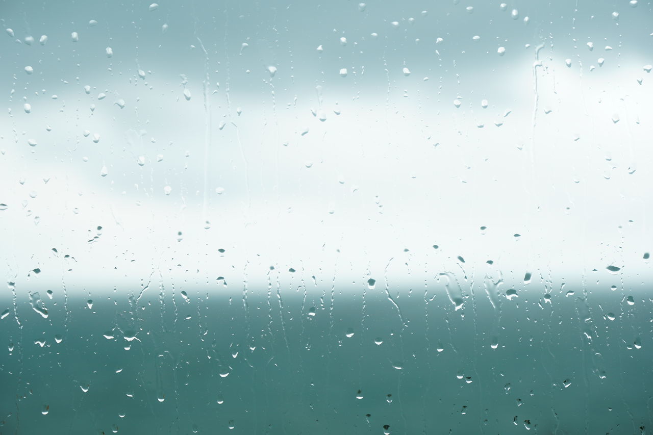 FULL FRAME SHOT OF RAINDROPS ON GLASS WINDOW