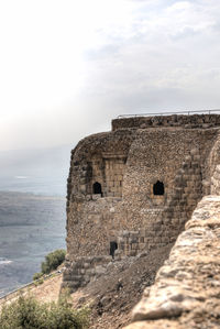 Old ruin building against cloudy sky