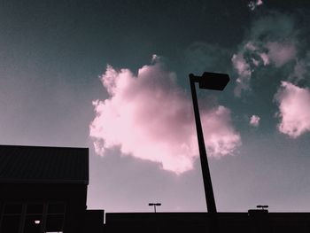 Low angle view of building against cloudy sky