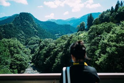 Rear view of woman against mountains