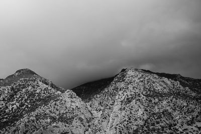 Scenic view of mountains against cloudy sky
