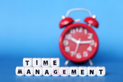 Close-up of clock against blue background