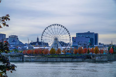 Ferris wheel in city against sky