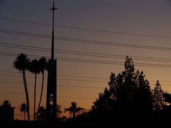 Low angle view of silhouette trees against sky at sunset